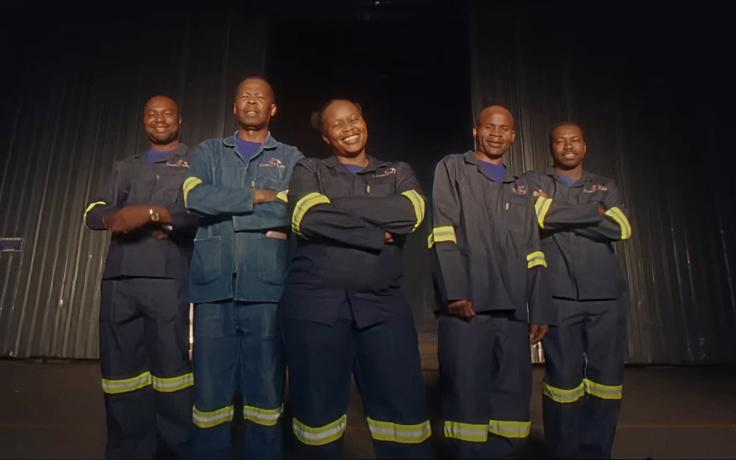 Enviro Loo workers in South Africa standing together smiling in front of a building. 