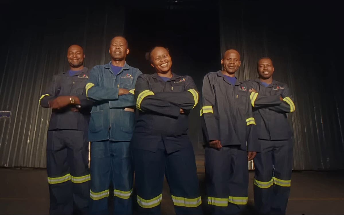 Enviro Loo workers in South Africa standing together smiling in front of a building.