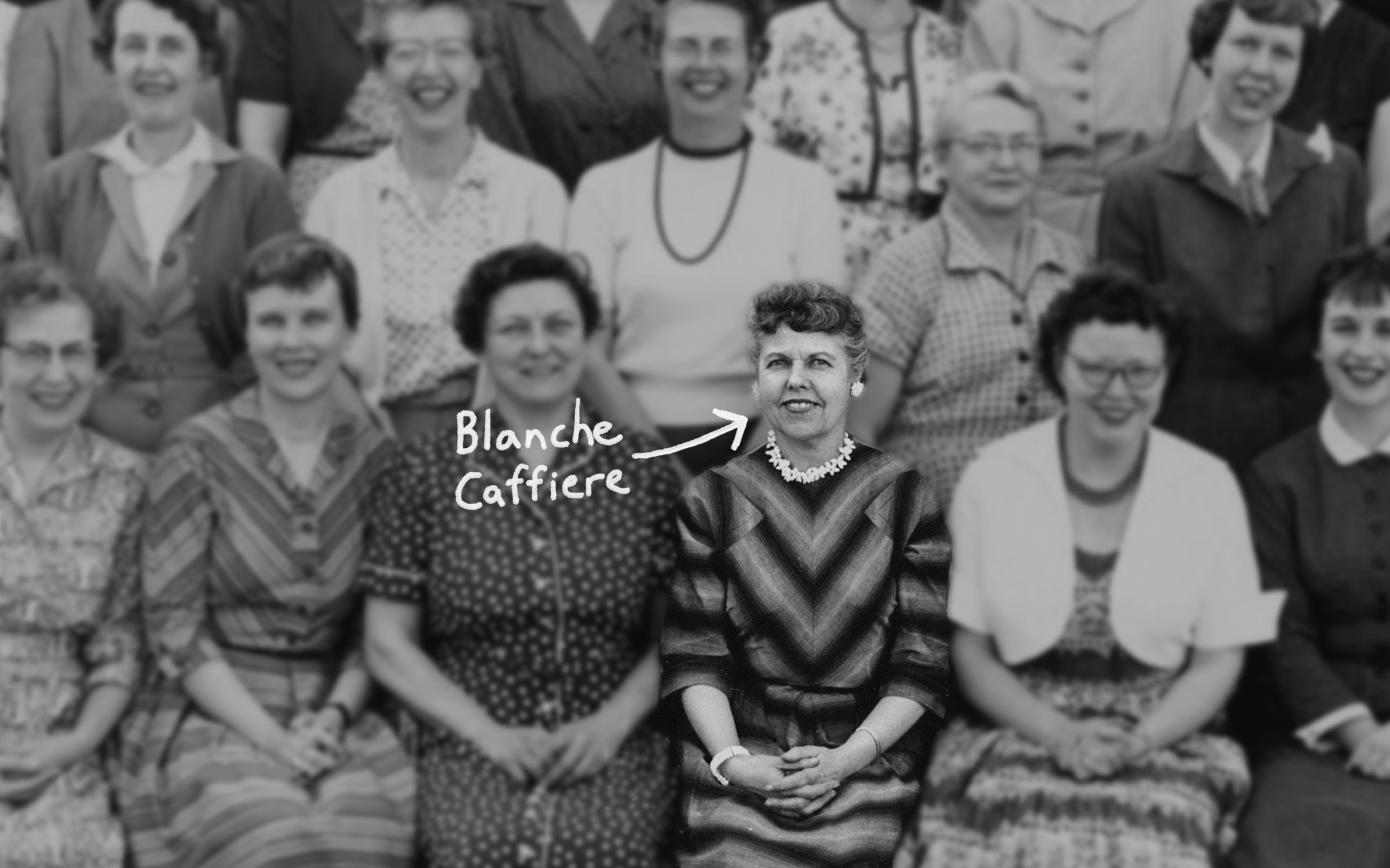 Blanche Caffiere sitting with a group of women smiling.