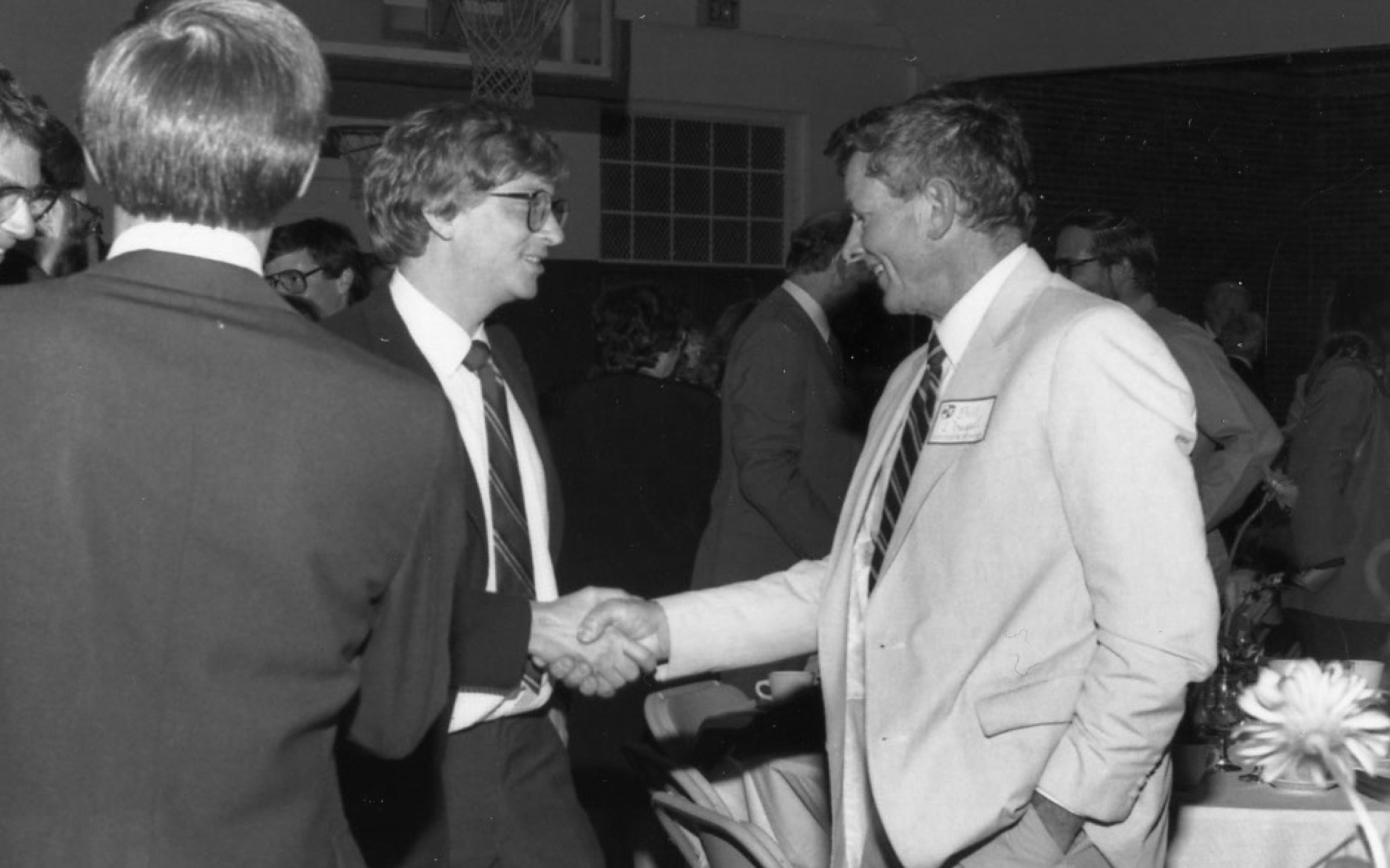 Bill Dougall smiling and shaking hands with Bill Gates at the Lakeside School Allen-Gates dedication.