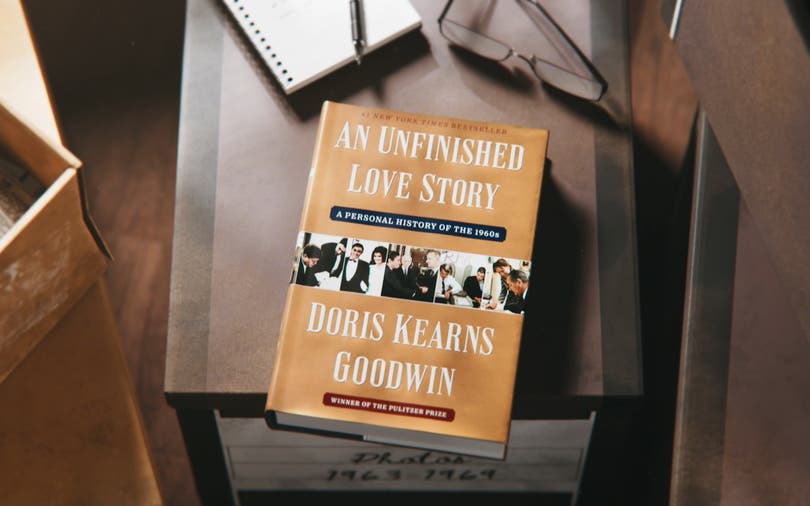 An Unfinished Love Story book sitting on a document file box.