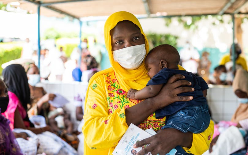 Portrait of a mother and four-month-old son after receiving the pentavalent vaccine, injectable and oral polio vaccines, in Dakar, Senegal.