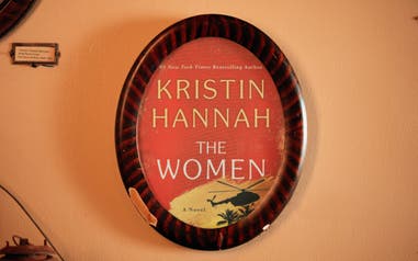 Graphic superimposed on a wall mirror with the book cover of “The Women” by Kristin Hannah.